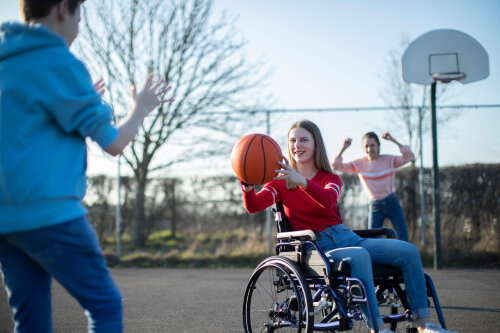 Teenage Girl In Wheelchair Playing Basketball With Friends © ©Daisy Daisy - stock.adobe.com