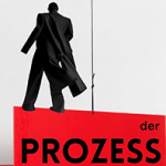 Die schwarze Silhouette eine Manns steht auf einem roten Schild mit der Aufschrift "Der Prozess"