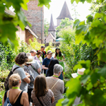 Führungsteilnehmerinnen und -teilnehmer im Heilkräutergarten am Hallertor