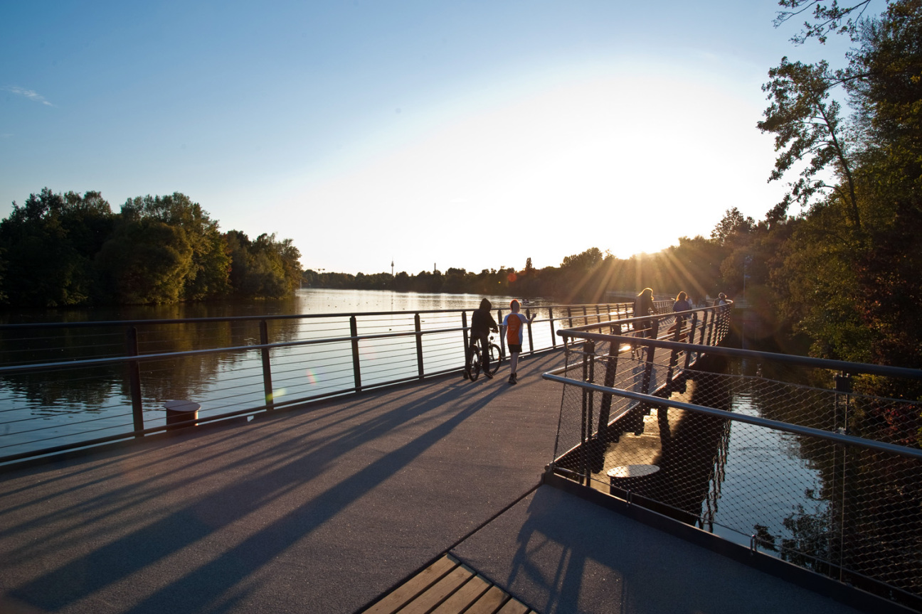 Bild © Christine Dierenbach / Stadt Nürnberg Spaziergänger auf dem Boulevardsteg am Wöhrder See bei Sonnenu, Bild © Christine Dierenbach / Stadt Nürnberg